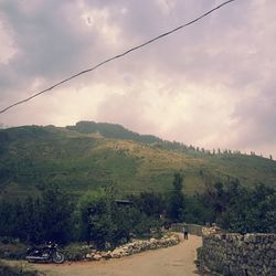 Scenic view of landscape against cloudy sky