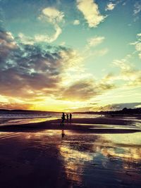 Scenic view of beach against sky during sunset