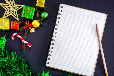 High angle view of blank book with christmas decorations on table