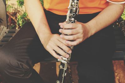 Midsection of man playing guitar