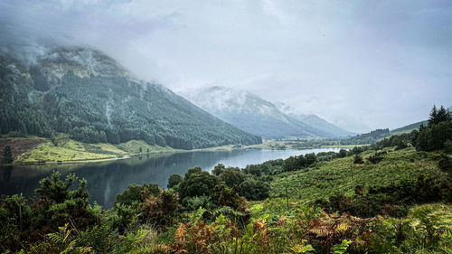 Scenic view of lake and mountains against sky