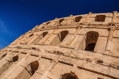 Low angle view of historical building against blue sky