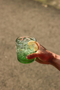 Cropped hand of woman holding drink