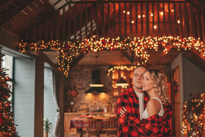 Candid authentic happy married couple spends time alone at lodge xmas decorated