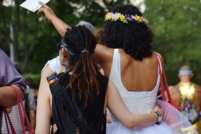 Rear view of women standing on the phone