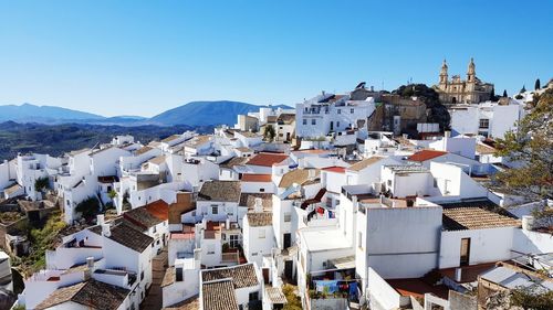 High angle view of town against clear blue sky