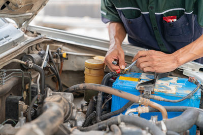 Midsection of man working at workshop