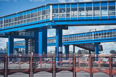 Train on bridge in city against sky