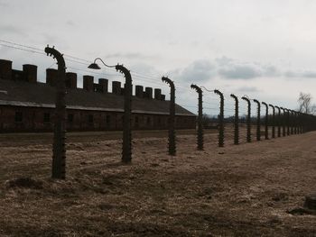 Fence on field against sky