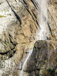 Low angle view of waterfall on rock formation