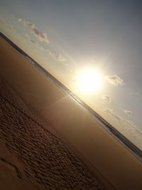 Scenic view of beach against sky during sunset