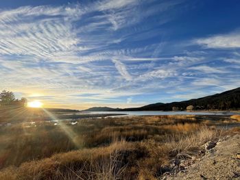Scenic view of landscape against bright sun