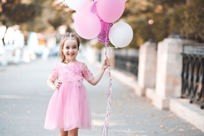 Portrait of cute girl with balloons