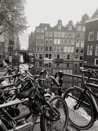 Bicycles parked on street by buildings in city