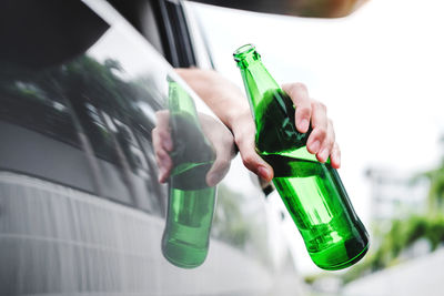 Close-up of hand holding glass bottle