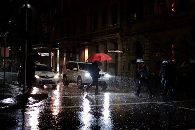 People on city street at night