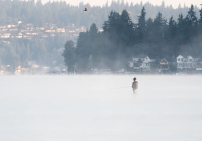 Man on snow against sky during winter