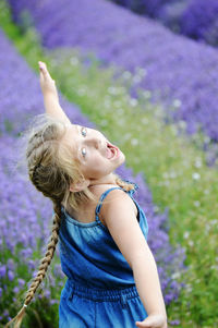 Portrait of girl with mouth open standing amidst plants