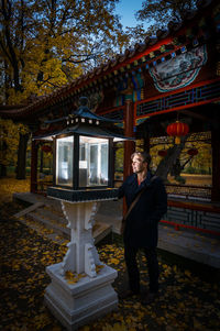 Full length of woman standing against trees