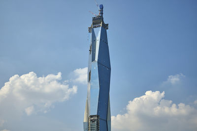 Low angle view of communications tower against sky