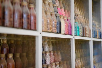 Full frame shot of bottles in shelf at store