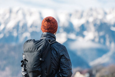 Rear view of man standing against sky