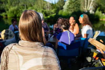 Rear view of people sitting outdoors