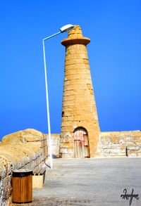 Low angle view of built structure against clear blue sky