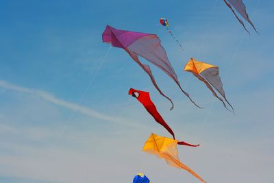 Low angle view of flags hanging against sky