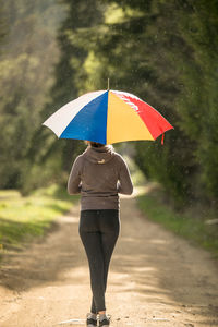 Woman standing on wet umbrella