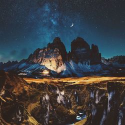 Panoramic view of rock formations against sky at night