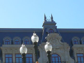 Low angle view of street light against building