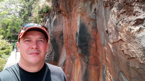 Portrait of teenage boy on rock