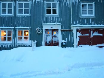 Snow covered houses by building