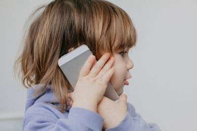 Rear view of woman using mobile phone