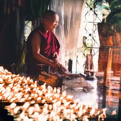 Woman preparing food at market stall