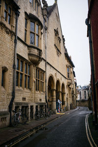 Street amidst buildings against sky in city