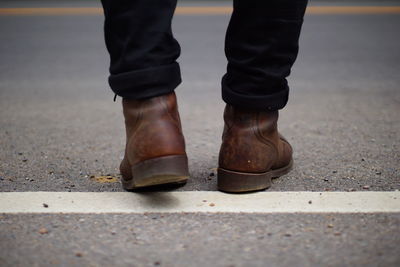 Low section of man standing on footpath