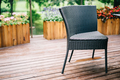 Empty chairs and table against potted plants