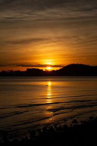 Scenic view of sea against romantic sky at sunset