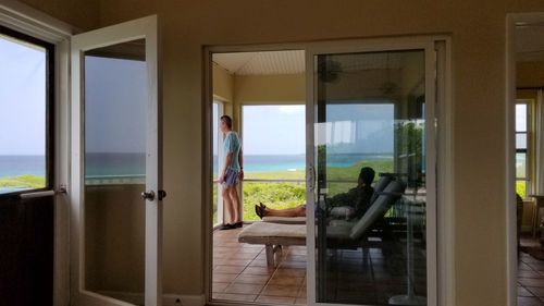 Men on porch seen through doorway