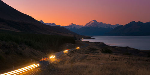 Light trails on mountain road at dusk