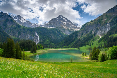 Scenic view of lake and mountains against sky