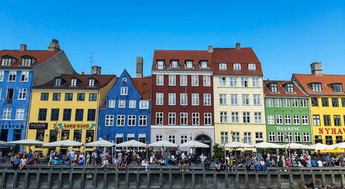 People on street against buildings in city of copenhagen