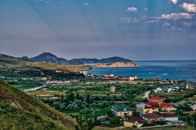 Townscape by sea against sky