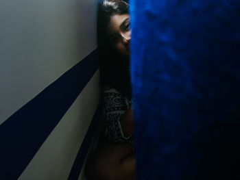 Close-up of young woman standing in mirror