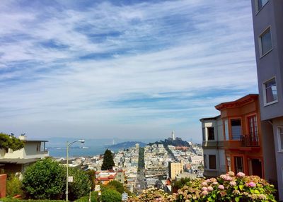 Buildings against cloudy sky