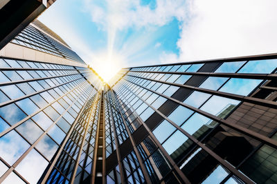 Low angle view of glass building against sky