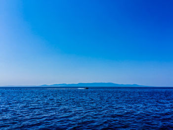 Scenic view of sea against clear blue sky