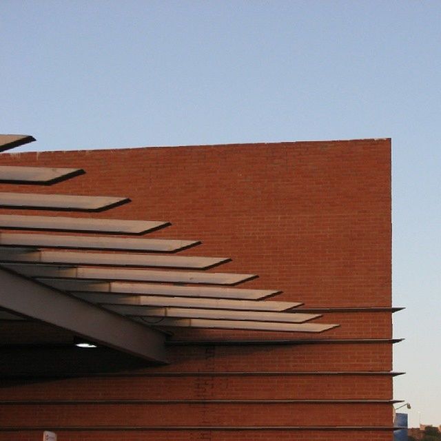 clear sky, copy space, built structure, building exterior, architecture, low angle view, roof, wood - material, in a row, house, repetition, no people, residential structure, pattern, day, high section, outdoors, brown, wooden, sunlight